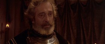 Movie still from “Flesh+Blood” (1985), directed by Paul Verhoeven – A person wearing a suit of armor; Close Up shot, Over the shoulder angle