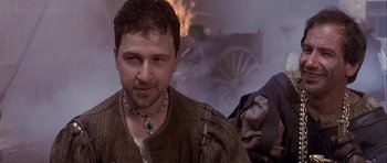 Movie still from “Flesh+Blood” (1985), directed by Paul Verhoeven – A person wearing a necklace; Close Up shot, Over the shoulder angle