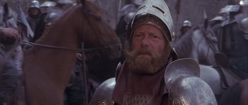 Movie still from “Flesh+Blood” (1985), directed by Paul Verhoeven – A person wearing a helmet; Close Up shot, Over the shoulder angle