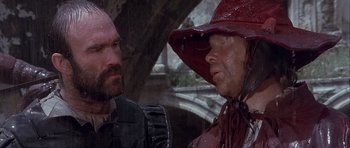 Movie still from “Flesh+Blood” (1985), directed by Paul Verhoeven – A man and a woman wearing a red hat; Close Up shot, Over the shoulder angle