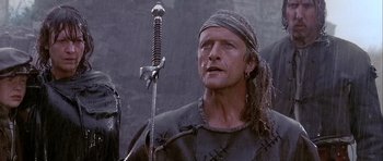 Movie still from “Flesh+Blood” (1985), directed by Paul Verhoeven – A person holding a sword; Close Up shot, Low angle