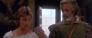Movie still from “Flesh+Blood” (1985), directed by Paul Verhoeven – A man and a woman are holding a rosary; Close Up shot, Over the shoulder angle