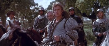 Movie still from “Flesh+Blood” (1985), directed by Paul Verhoeven – A group of people in medieval garb on horseback; Medium shot, Low angle