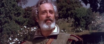 Movie still from “Flesh+Blood” (1985), directed by Paul Verhoeven – An older man with a beard and a white beard; Close Up shot, Low angle