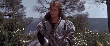 Movie still from “Flesh+Blood” (1985), directed by Paul Verhoeven – A young man in medieval garb holding a horse; Close Up shot, Low angle