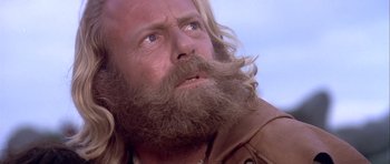 Movie still from “Flesh+Blood” (1985), directed by Paul Verhoeven – A person with a long beard; Close Up shot, Low angle