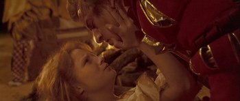 Movie still from “Flesh+Blood” (1985), directed by Paul Verhoeven – A man and a woman are kissing in a room; Close Up shot, Low angle