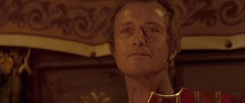 Movie still from “Flesh+Blood” (1985), directed by Paul Verhoeven – A person wearing a red and gold shirt; Close Up shot, Low angle