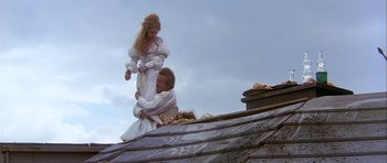 Movie still from “Flesh+Blood” (1985), directed by Paul Verhoeven – A man and a woman on top of a roof; Wide shot, Low angle