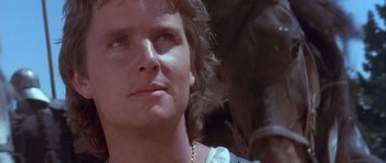 Movie still from “Flesh+Blood” (1985), directed by Paul Verhoeven – A person with a horse in the background; Close Up shot, Low angle