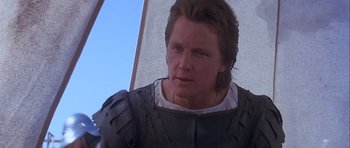 Movie still from “Flesh+Blood” (1985), directed by Paul Verhoeven – A person wearing a suit of armor; Close Up shot, Over the shoulder angle