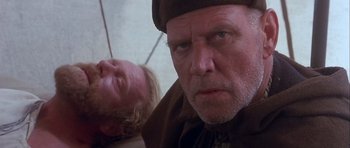 Movie still from “Flesh+Blood” (1985), directed by Paul Verhoeven – A man and a woman are looking at the camera; Close Up shot, Low angle