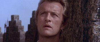 Movie still from “Flesh+Blood” (1985), directed by Paul Verhoeven – A person wearing a necklace; Close Up shot, Low angle