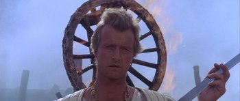 Movie still from “Flesh+Blood” (1985), directed by Paul Verhoeven – A person wearing a necklace; Close Up shot, Low angle