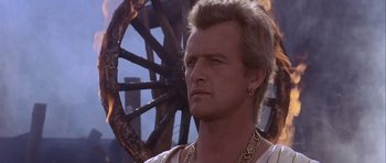 Movie still from “Flesh+Blood” (1985), directed by Paul Verhoeven – A person wearing a necklace; Close Up shot, Low angle