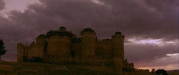 Movie still from “Flesh+Blood” (1985), directed by Paul Verhoeven – A castle with a dark sky in the background; Extreme Wide shot, Low angle