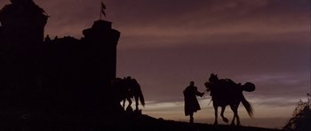Movie still from “Flesh+Blood” (1985), directed by Paul Verhoeven – A man on a horse is standing in front of a tower; Extreme Wide shot, Low angle