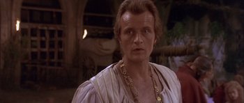 Movie still from “Flesh+Blood” (1985), directed by Paul Verhoeven – A person wearing a necklace; Close Up shot, Over the shoulder angle