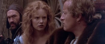 Movie still from “Flesh+Blood” (1985), directed by Paul Verhoeven – A man and a woman standing next to each other; Close Up shot, Over the shoulder angle