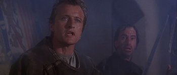 Movie still from “Flesh+Blood” (1985), directed by Paul Verhoeven – A man with a knife in his mouth and another man with a knife in his mouth; Close Up shot, Low angle