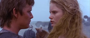 Movie still from “Flesh+Blood” (1985), directed by Paul Verhoeven – A man and a woman face to face in a field; Close Up shot, Over the shoulder angle