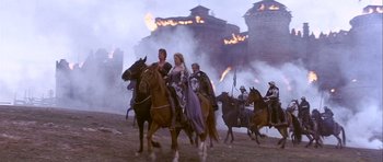 Movie still from “Flesh+Blood” (1985), directed by Paul Verhoeven – A group of people riding horses through a field; Wide shot, High angle
