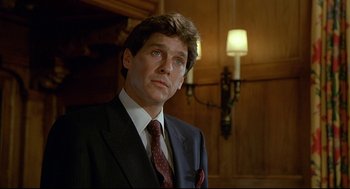 Movie still from “Fletch” (1985), directed by Michael Ritchie – A person wearing a suit and tie; Close Up shot, Low angle