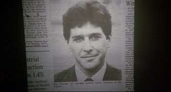 Movie still from “Fletch” (1985), directed by Michael Ritchie – A black and white photo of a man in suit and tie; Extreme Close Up shot, Overhead angle