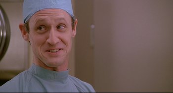 Movie still from “Fletch” (1985), directed by Michael Ritchie – A person wearing a surgical cap; Close Up shot, Low angle