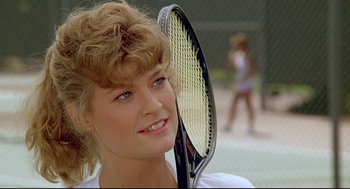 Movie still from “Fletch” (1985), directed by Michael Ritchie – A person holding a tennis racquet; Close Up shot, Low angle