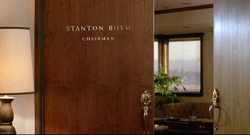 Movie still from “Fletch” (1985), directed by Michael Ritchie – The door of the stanton boyd chairman's office; Medium shot, Low angle