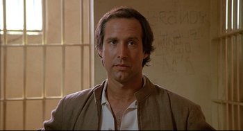 Movie still from “Fletch” (1985), directed by Michael Ritchie – A person wearing a shirt and a jacket; Close Up shot, Low angle
