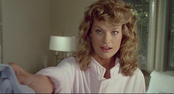 Movie still from “Fletch” (1985), directed by Michael Ritchie – A person with long hair; Close Up shot, Over the shoulder angle