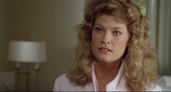 Movie still from “Fletch” (1985), directed by Michael Ritchie – A person with long hair; Close Up shot, Over the shoulder angle