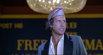 Movie still from “Fletch” (1985), directed by Michael Ritchie – A man wearing a hat and a suit; Close Up shot, Low angle