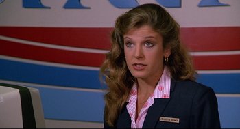 Movie still from “Fletch” (1985), directed by Michael Ritchie – A person wearing a suit and tie; Close Up shot, Over the shoulder angle