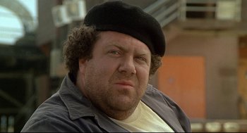 Movie still from “Fletch” (1985), directed by Michael Ritchie – A person wearing a hat; Close Up shot, Low angle