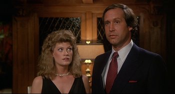 Movie still from “Fletch” (1985), directed by Michael Ritchie – A man and a woman standing next to each other; Close Up shot, Low angle