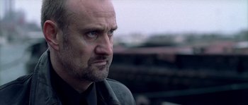 Movie still from “Flickering Lights” (2000), directed by Anders Thomas Jensen – A person with a beard; Close Up shot, Low angle