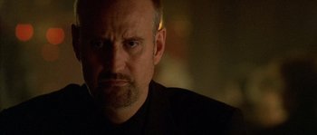 Movie still from “Flickering Lights” (2000), directed by Anders Thomas Jensen – A person wearing a black shirt; Close Up shot, Low angle