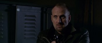Movie still from “Flickering Lights” (2000), directed by Anders Thomas Jensen – A person holding a gun; Close Up shot, Low angle