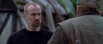 Movie still from “Flickering Lights” (2000), directed by Anders Thomas Jensen – A person looking at another person; Close Up shot, Low angle