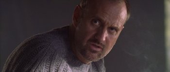 Movie still from “Flickering Lights” (2000), directed by Anders Thomas Jensen – A person wearing a sweater; Close Up shot, Low angle
