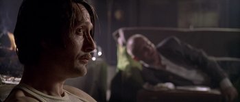 Movie still from “Flickering Lights” (2000), directed by Anders Thomas Jensen – A person with a beard; Close Up shot, Over the shoulder angle