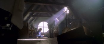 Movie still from “Flickering Lights” (2000), directed by Anders Thomas Jensen – Two people are sitting on the floor in a room; Wide shot, Low angle