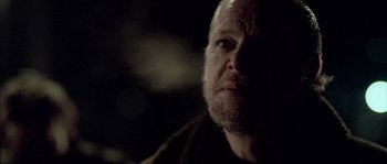 Movie still from “Flickering Lights” (2000), directed by Anders Thomas Jensen – A person with a beard; Close Up shot, Over the shoulder angle