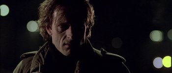Movie still from “Flickering Lights” (2000), directed by Anders Thomas Jensen – A person wearing a jacket; Close Up shot, Low angle