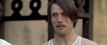 Movie still from “Flickering Lights” (2000), directed by Anders Thomas Jensen – A person with long black hair; Close Up shot, Over the shoulder angle