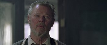 Movie still from “Flickering Lights” (2000), directed by Anders Thomas Jensen – An older man with a beard and a mustache; Close Up shot, Low angle