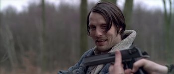 Movie still from “Flickering Lights” (2000), directed by Anders Thomas Jensen – A person holding a gun; Close Up shot, Low angle